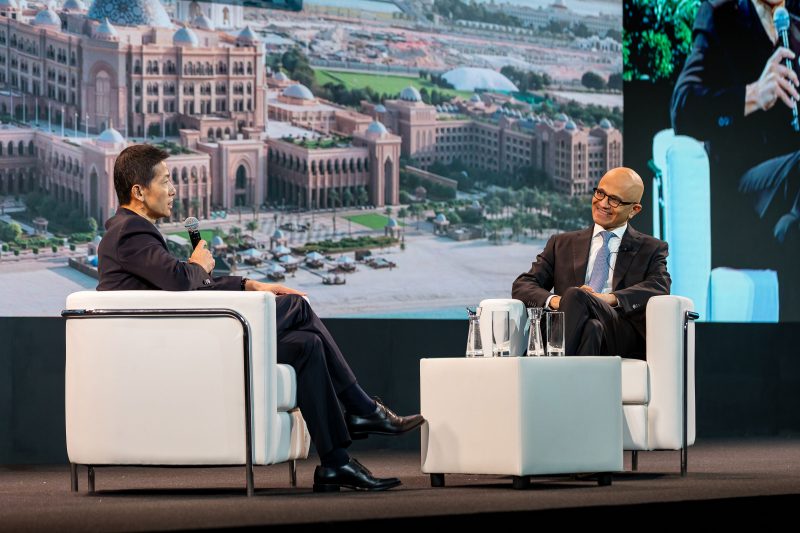 Microsoft Chairman and CEO Satya Nadella in a fireside chat with a male guest on stage