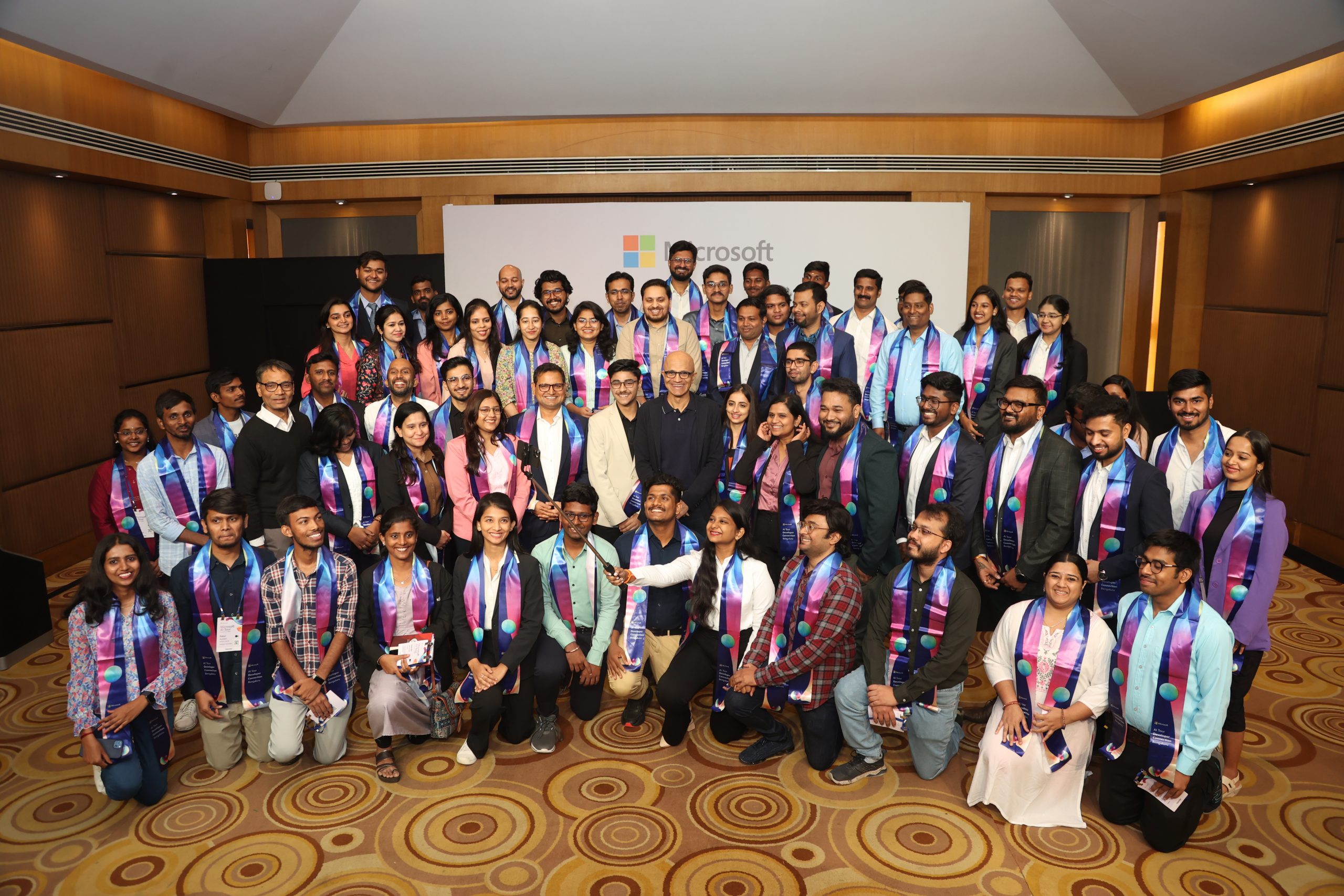 Large group of people posing for a photo with Microsoft chairman and CEO Satya Nadella