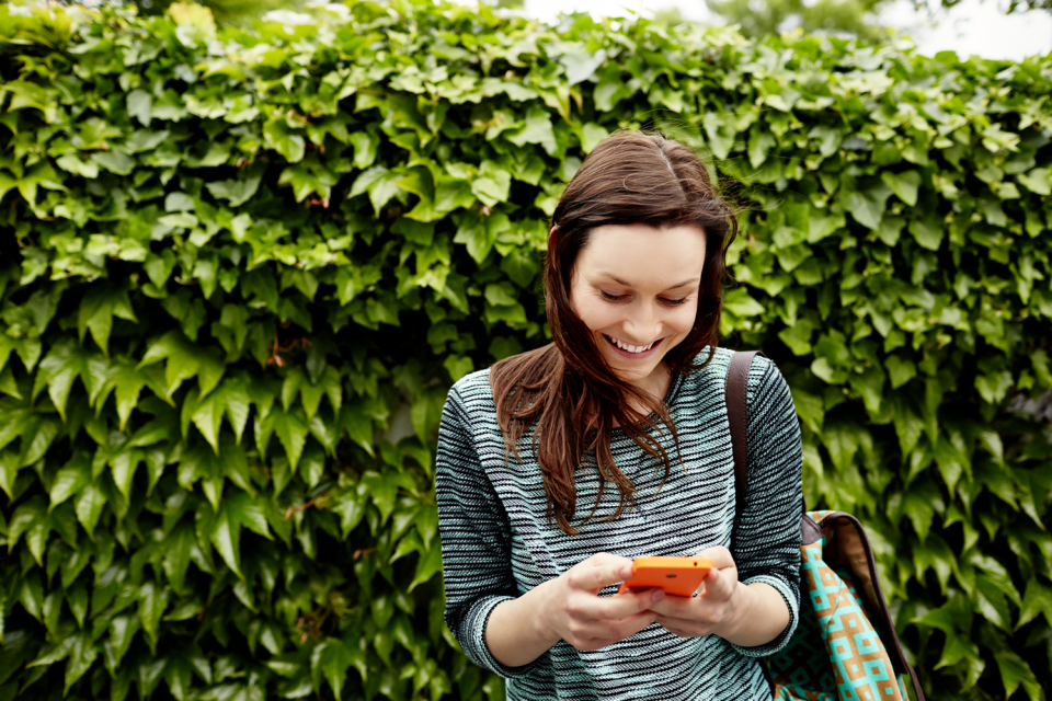 Girl using Microsoft Lumia smartphone with apps in summer