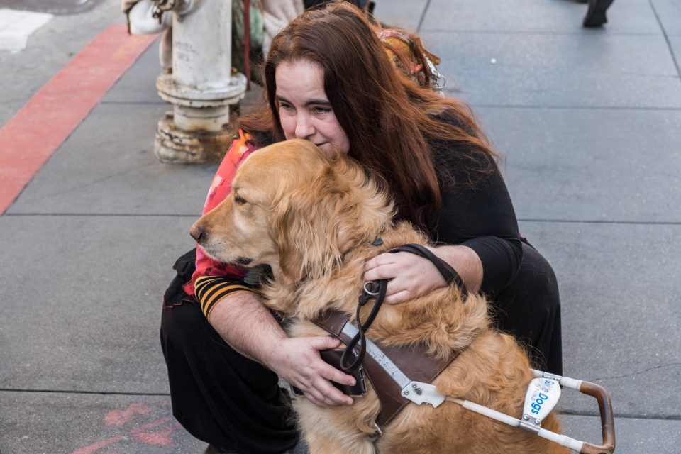 Woman hugging her guide dog