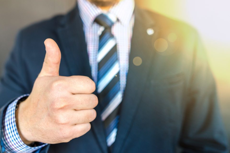 Man in suit giving thumbs-up