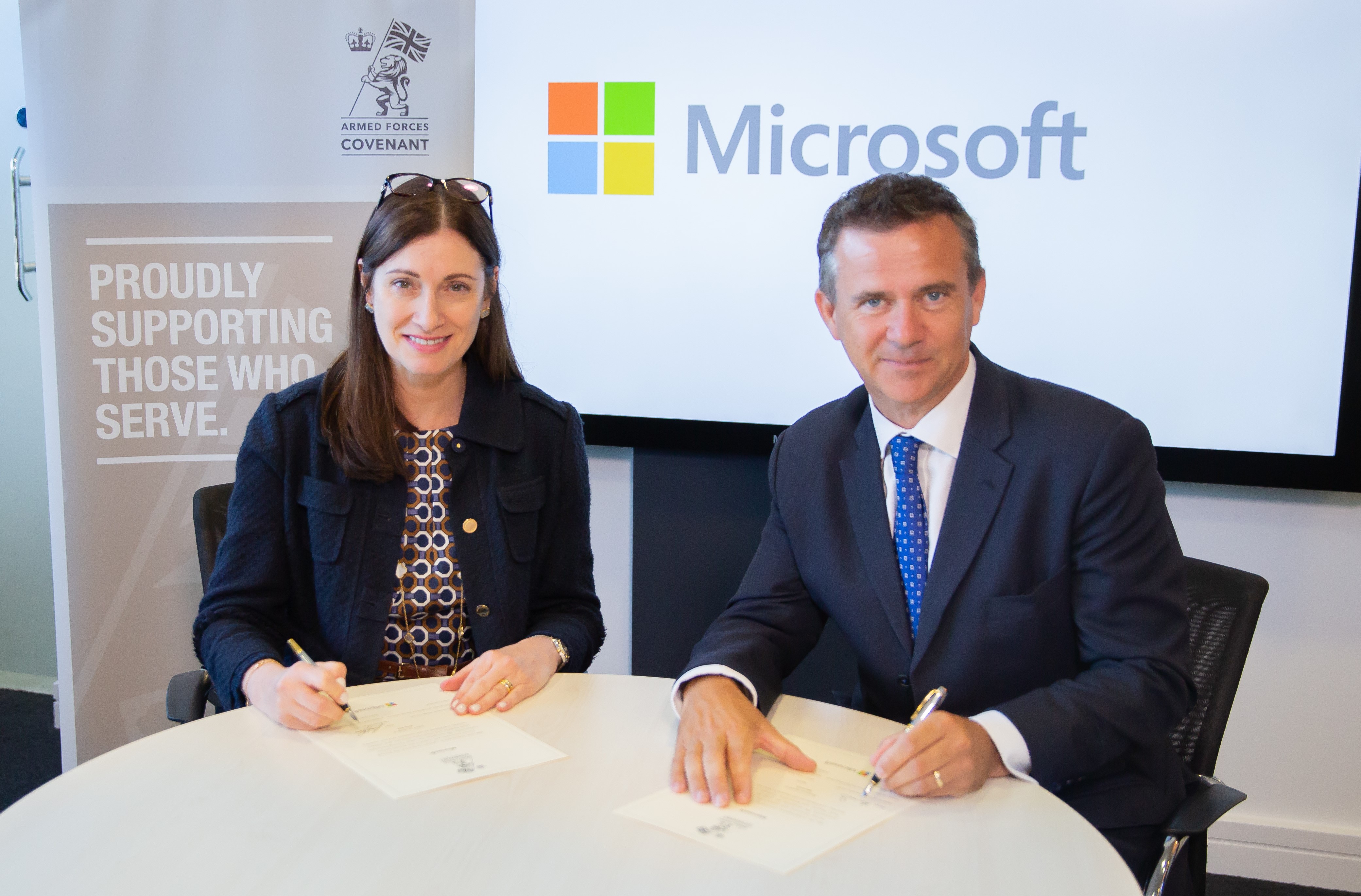 Cindy Rose, Chief Executive of Microsoft UK, and Mark Lancaster MP, the Minister of State for the Armed Forces, sign the Armed Forces Covenant