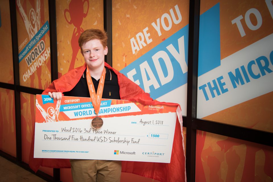 Adam Drummond, who won a bronze medal at the Microsoft Office Specialist World Championship for his knowledge of Word, with his cheque for $1,500