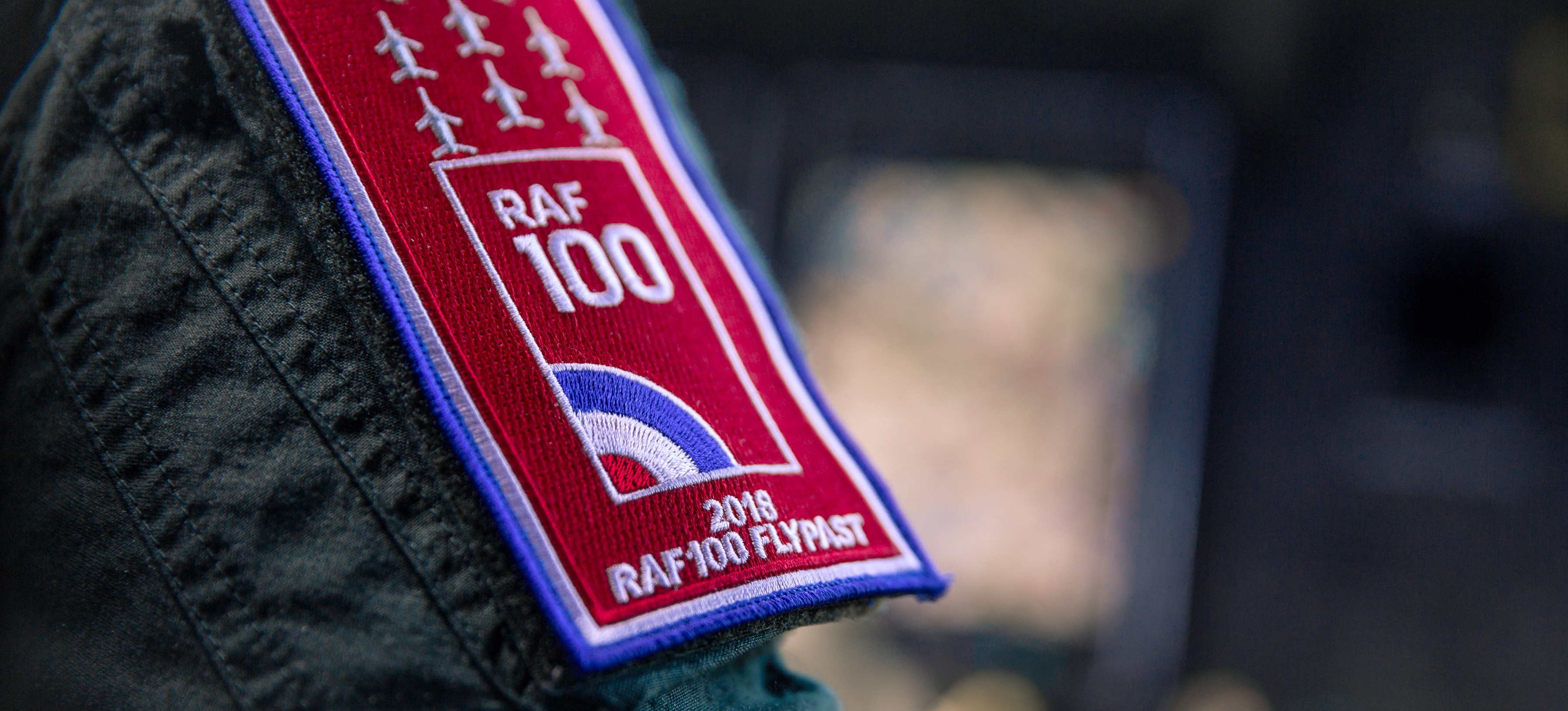 RAF 100 badge on the sleeve of an RAF helicopter pilot about to take part in the Centenary Flypast over Buckingham Palace in London