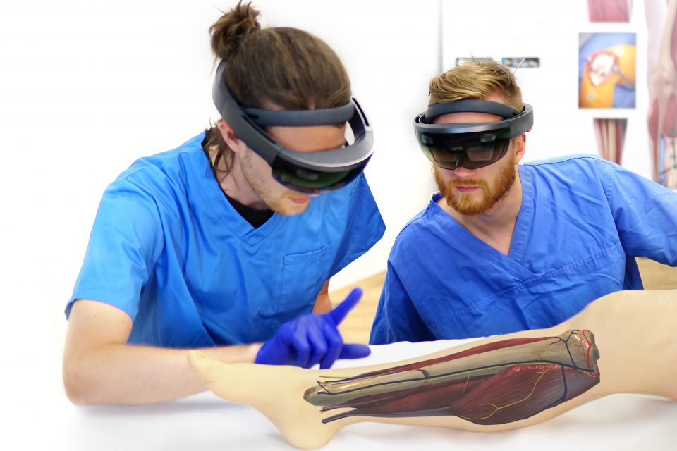 Two surgeons using HoloLens to look at leg during operation