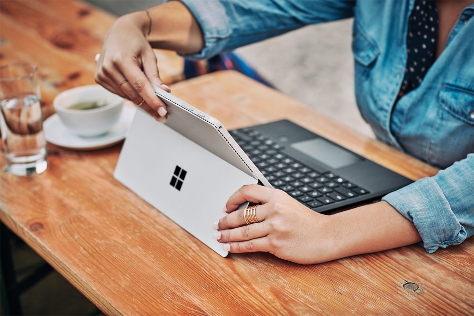 woman turning on a Surface laptop