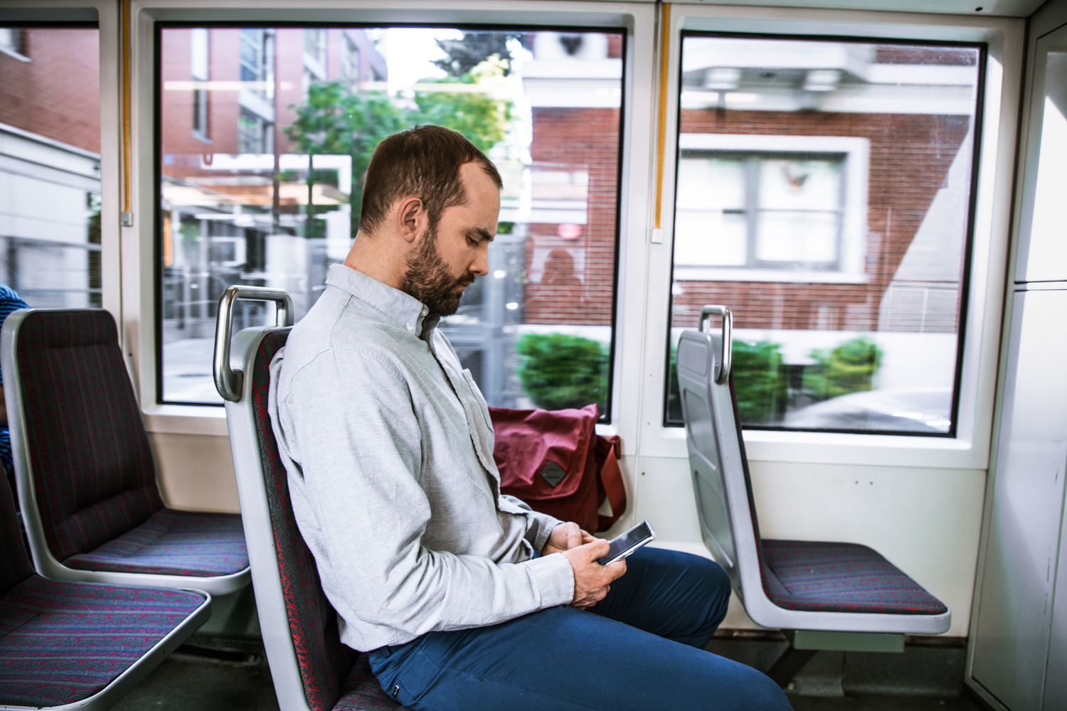 Man using phone on bus