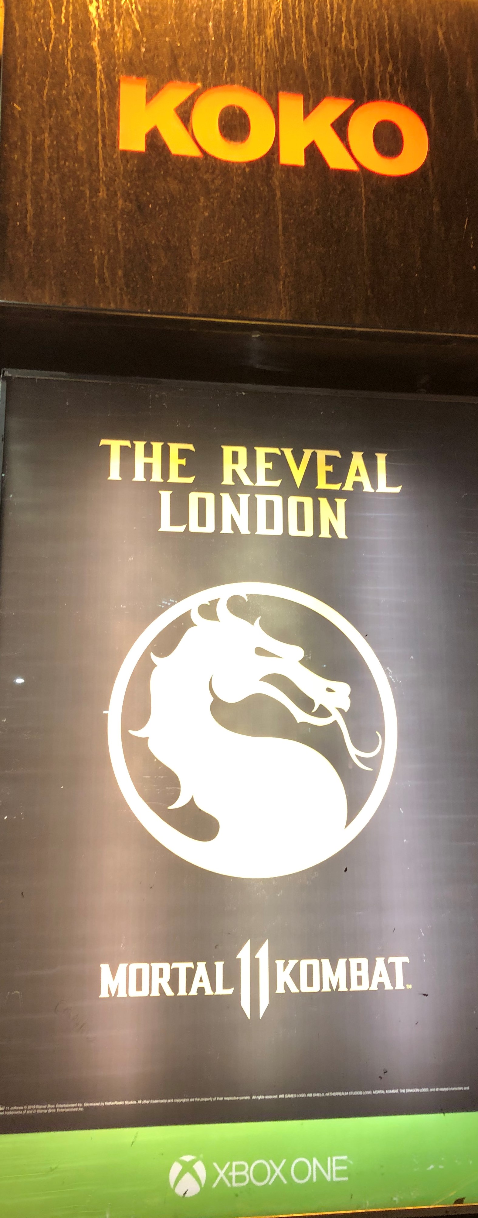 Poster showing Mortal Kombat symbol and the words "The reveal, London"