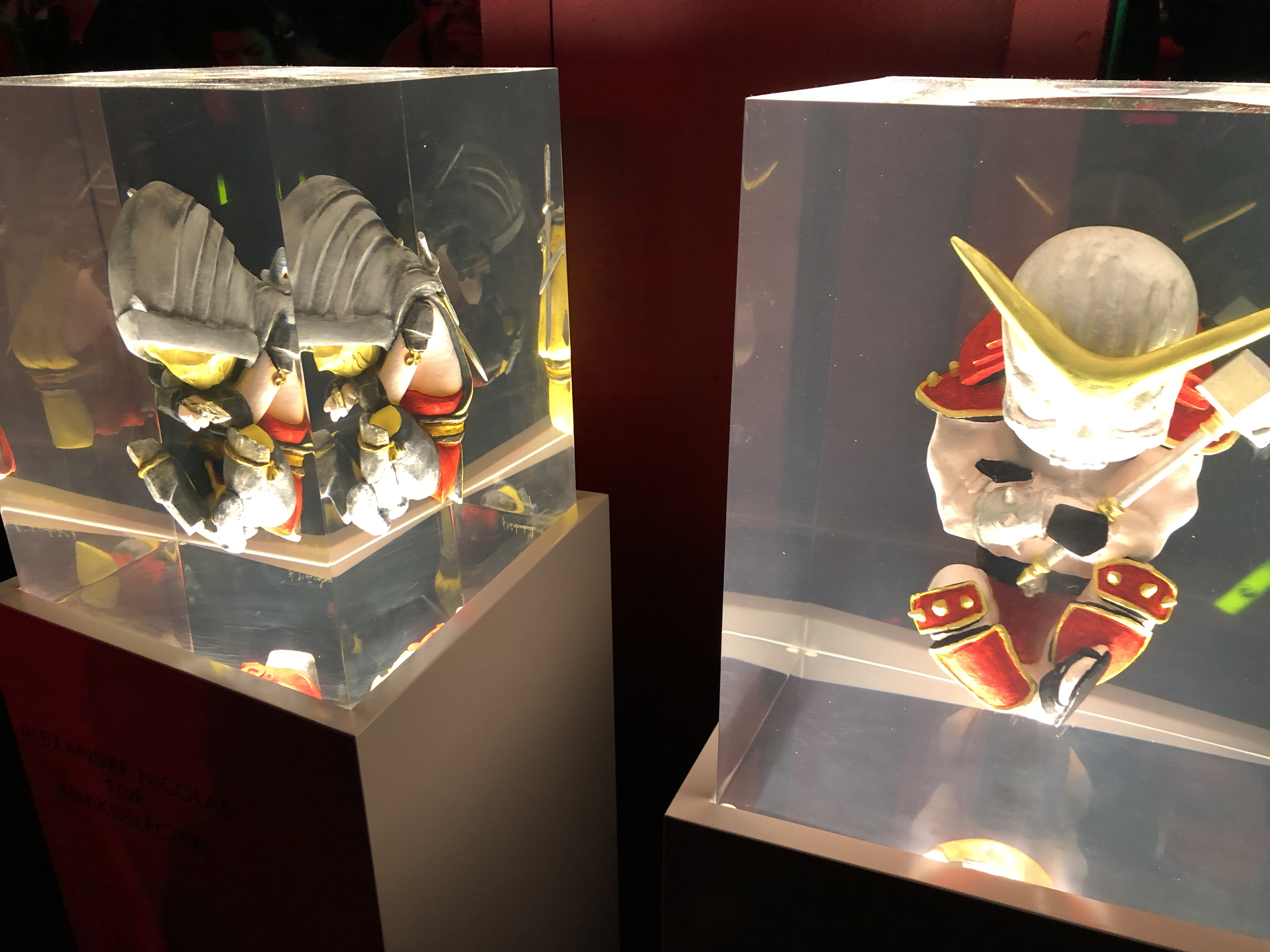 Mortal Kombat 11 figures are seen in glass boxes