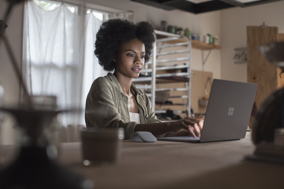 Woman using Surface Book at home