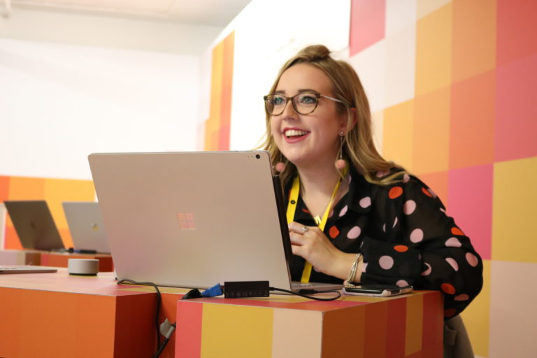 A girl smiles while using a Surface device at D&AD