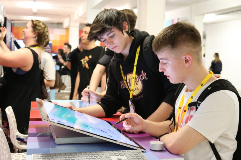 Two boys draw on a Surface Studio at D&AD