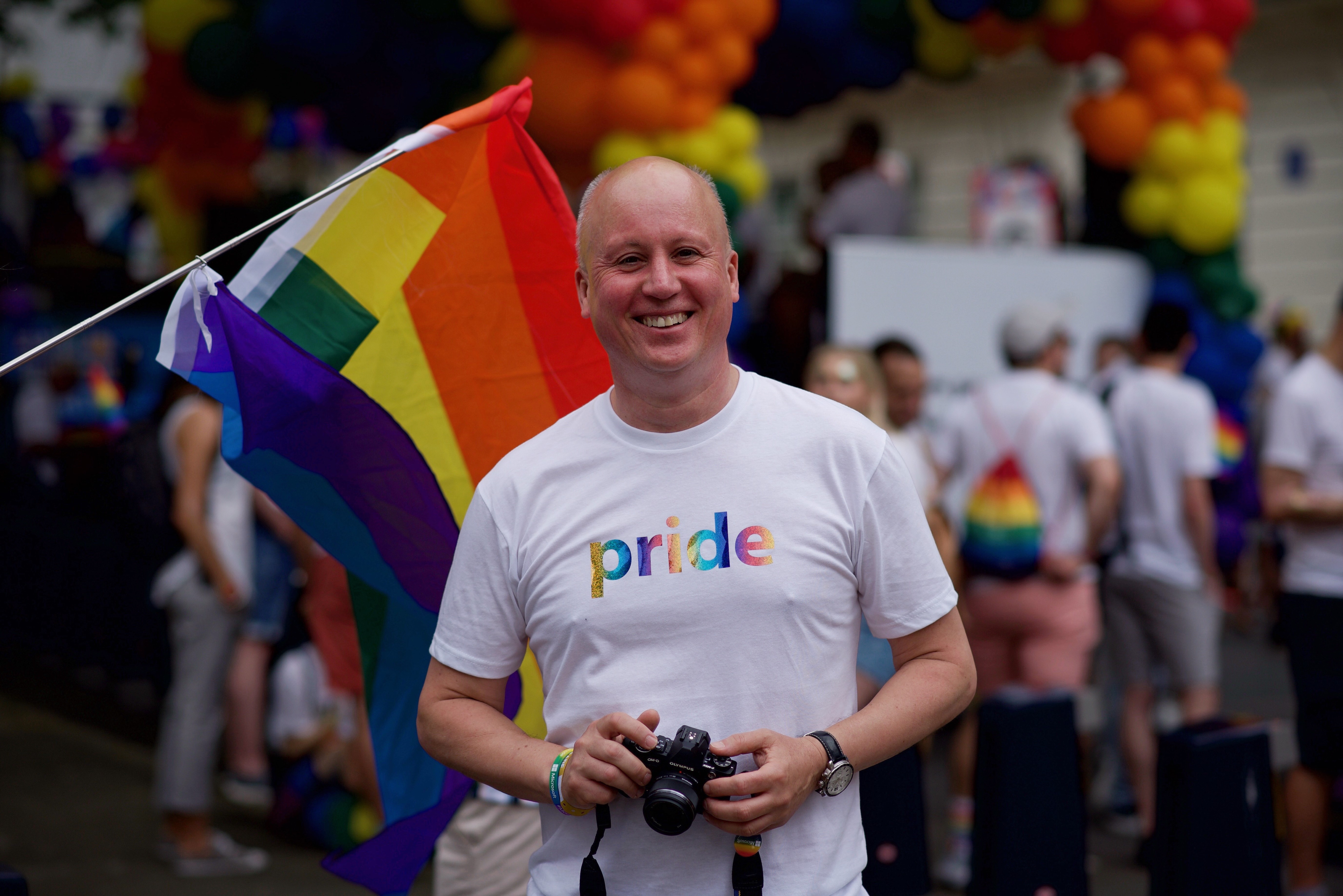 A Microsoft staff member holds a camera during PRIDE in London