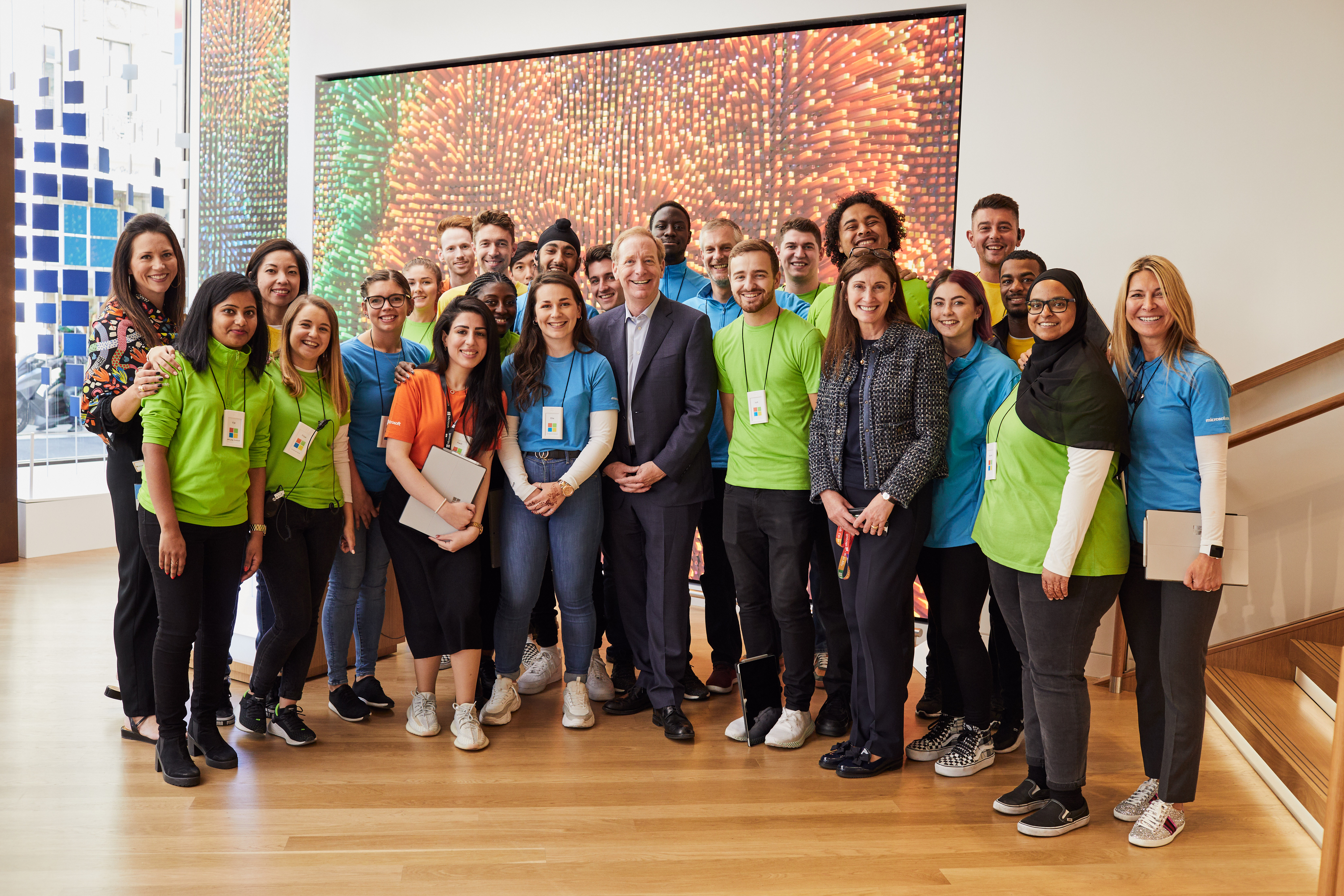 Brad Smith with Cindy Rose, Microsoft UK CEO, and Microsoft Store staff in London