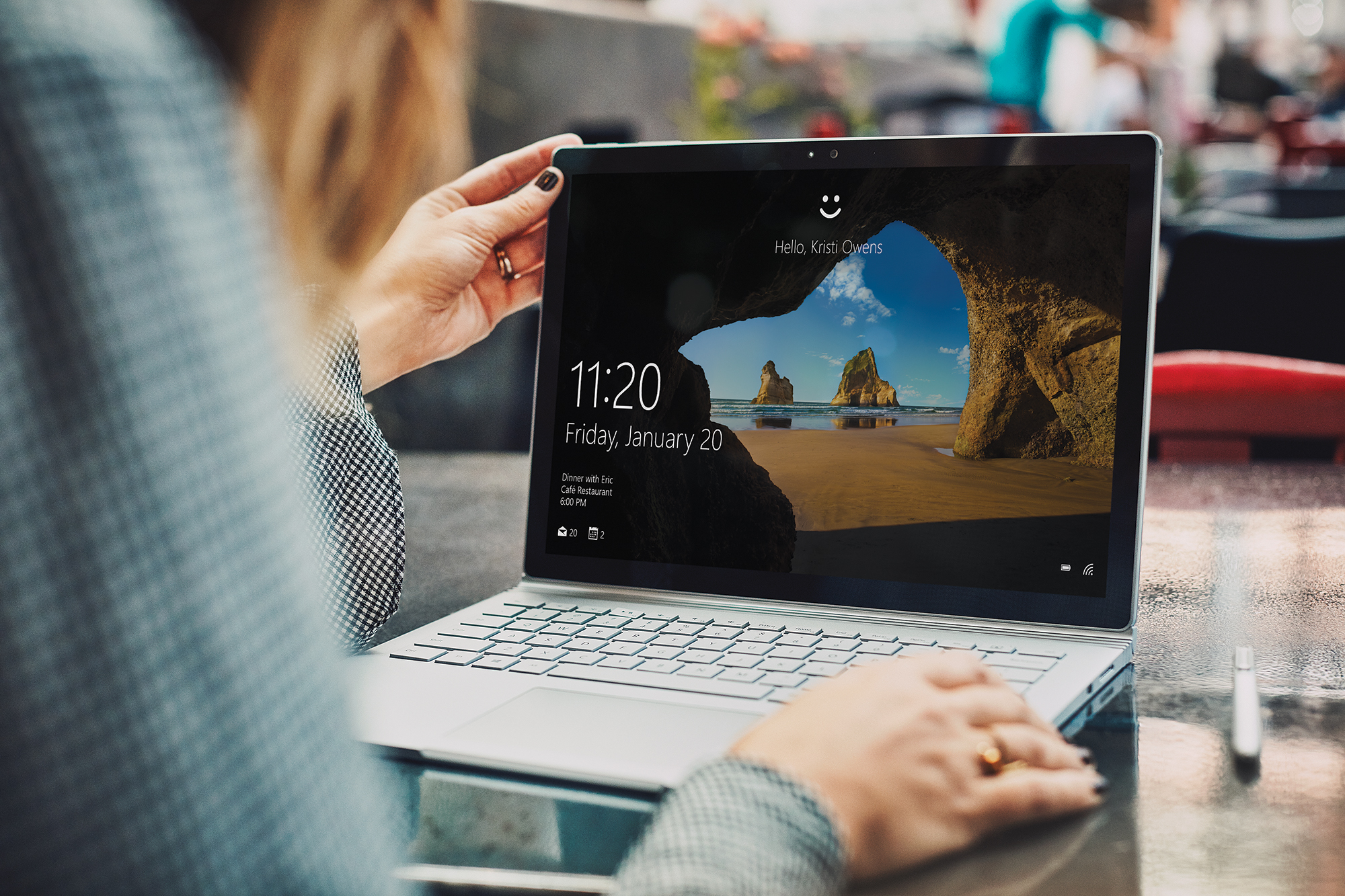 A woman uses Windows Hello on her laptop
