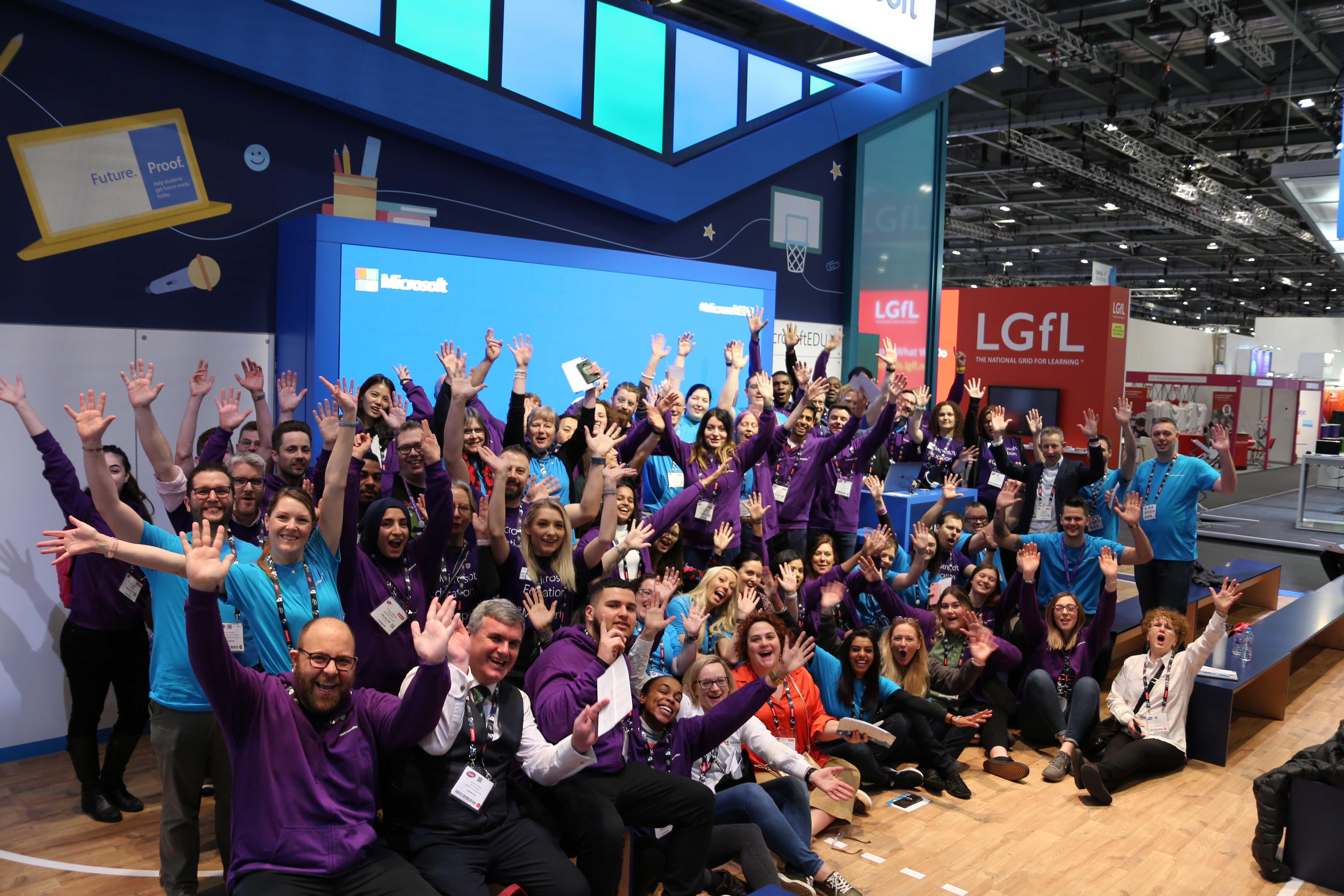 Microsoft staff cheer on their stand at Bett