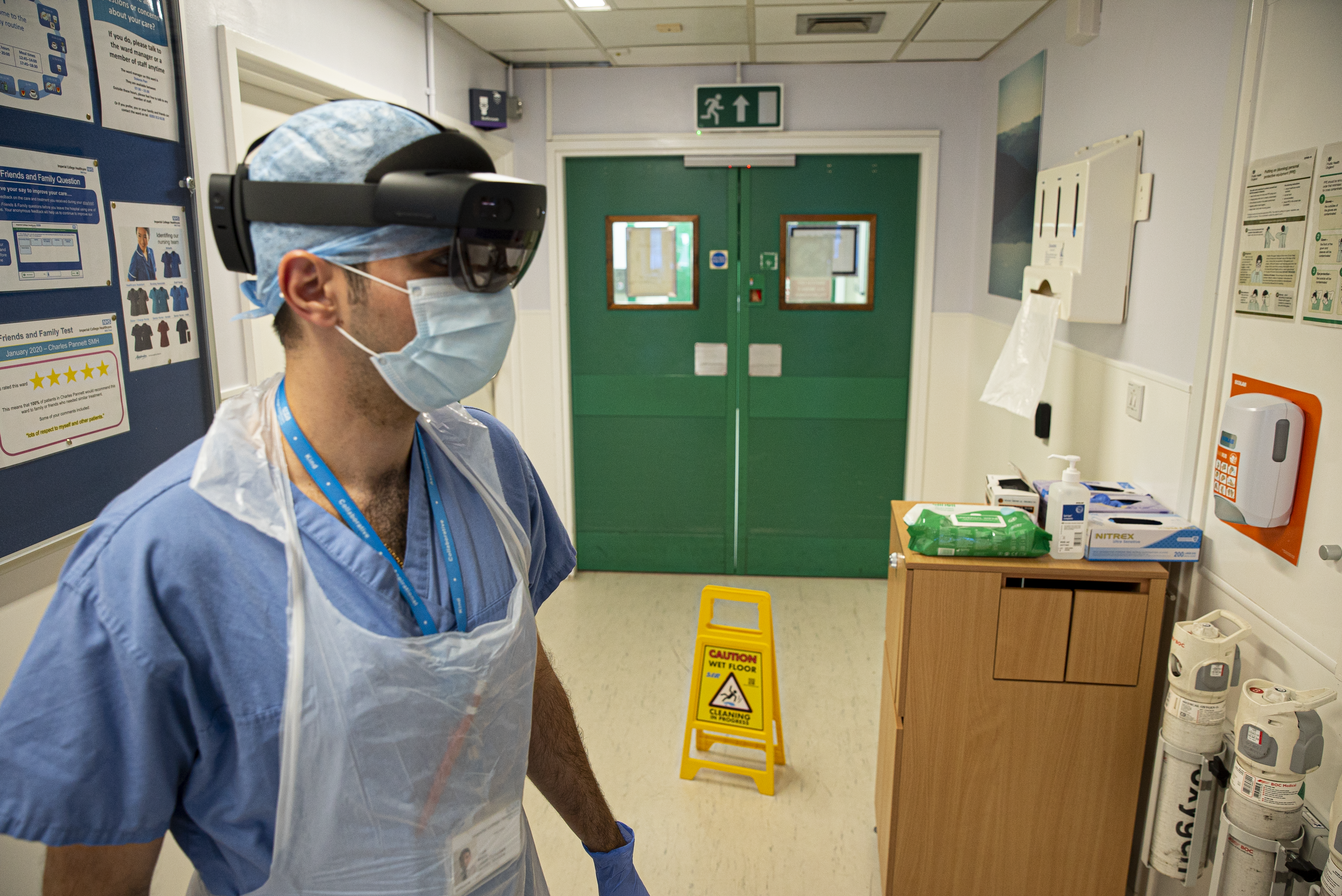 A doctor wearing a HoloLens enters a COVID-19 ward