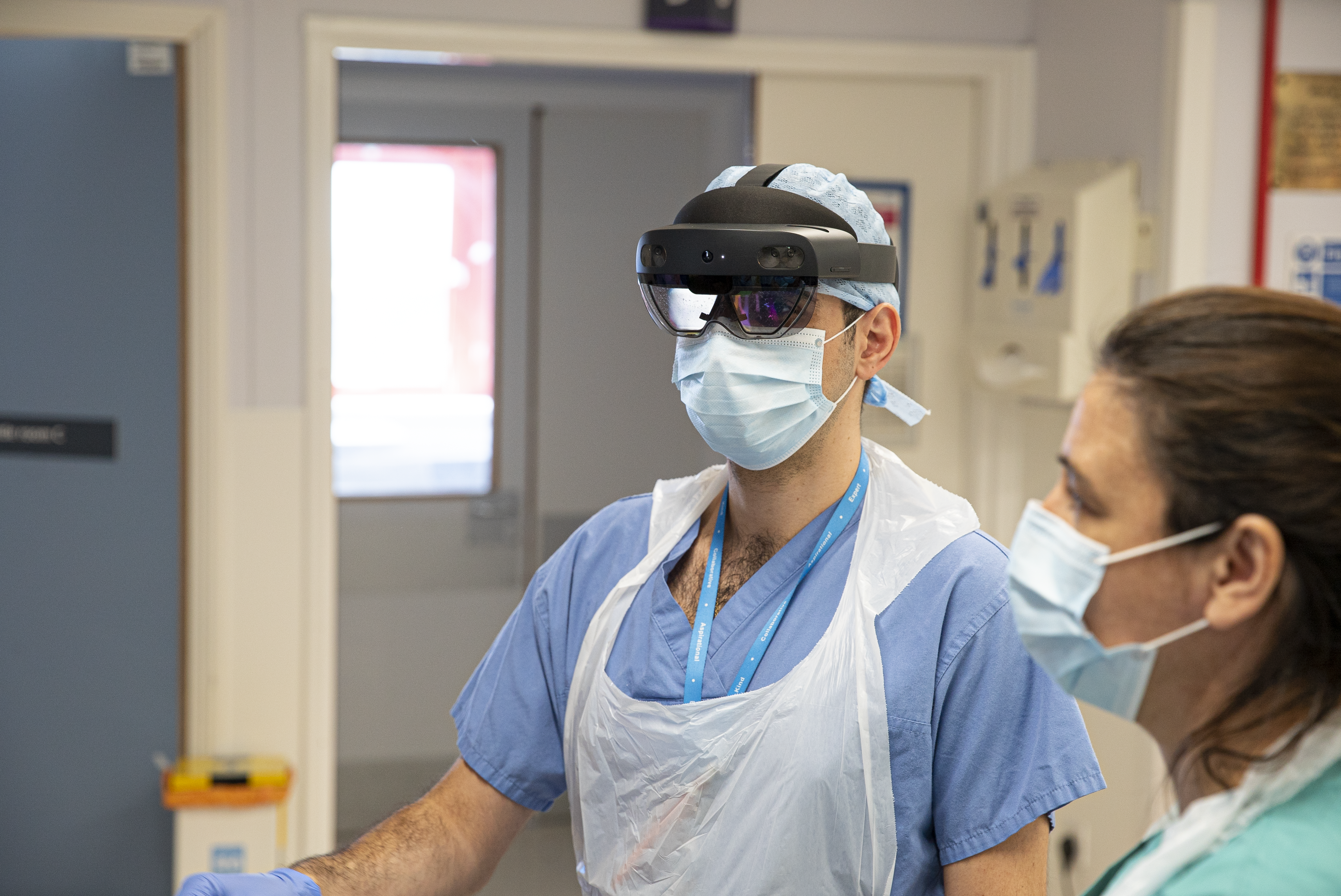 An NHS doctor wears HoloLens 2 and PPE