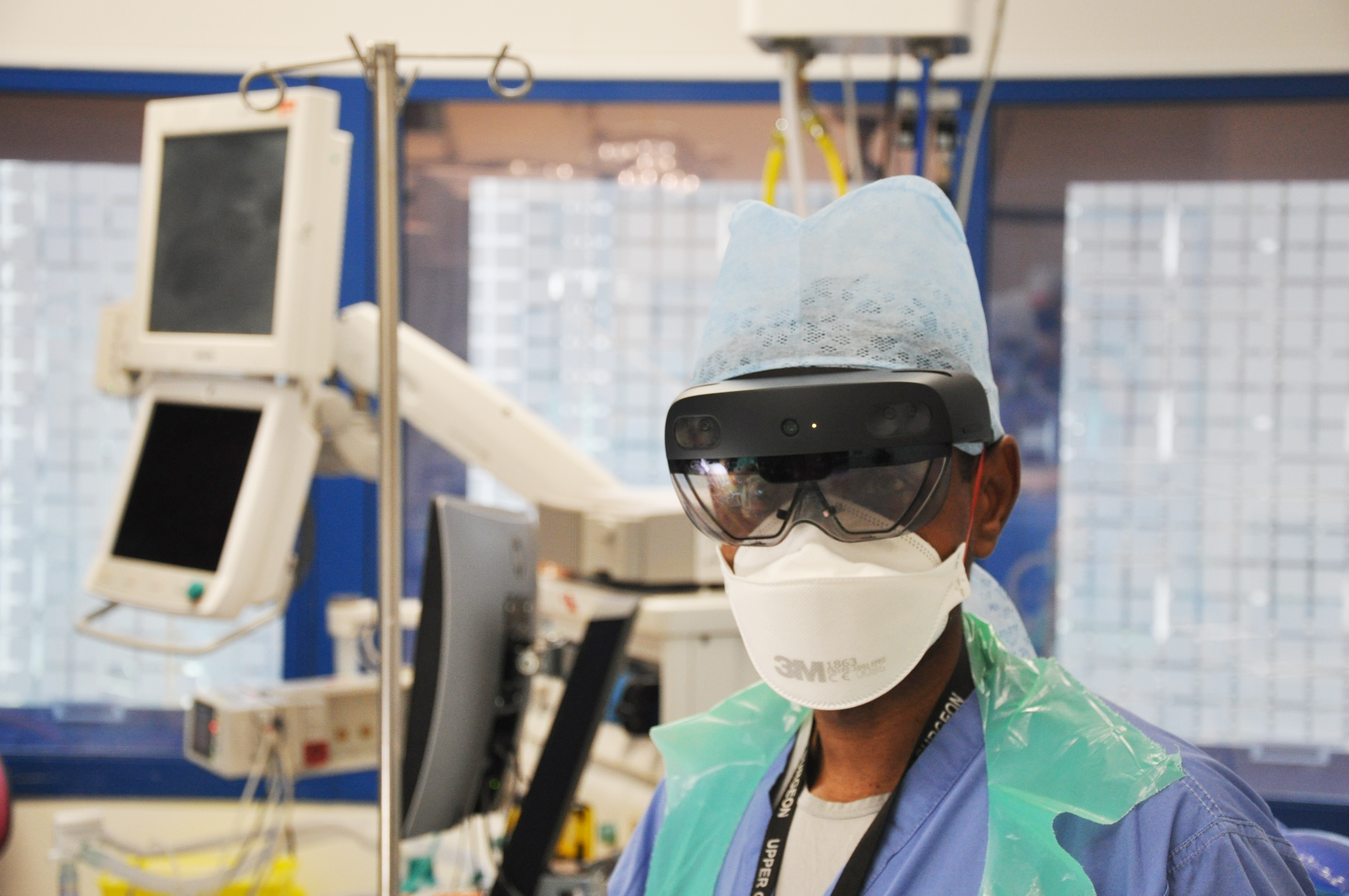NHS surgeon prepares for surgery during the COVID-19 outbreak wearing a Microsoft HoloLens and full PPE