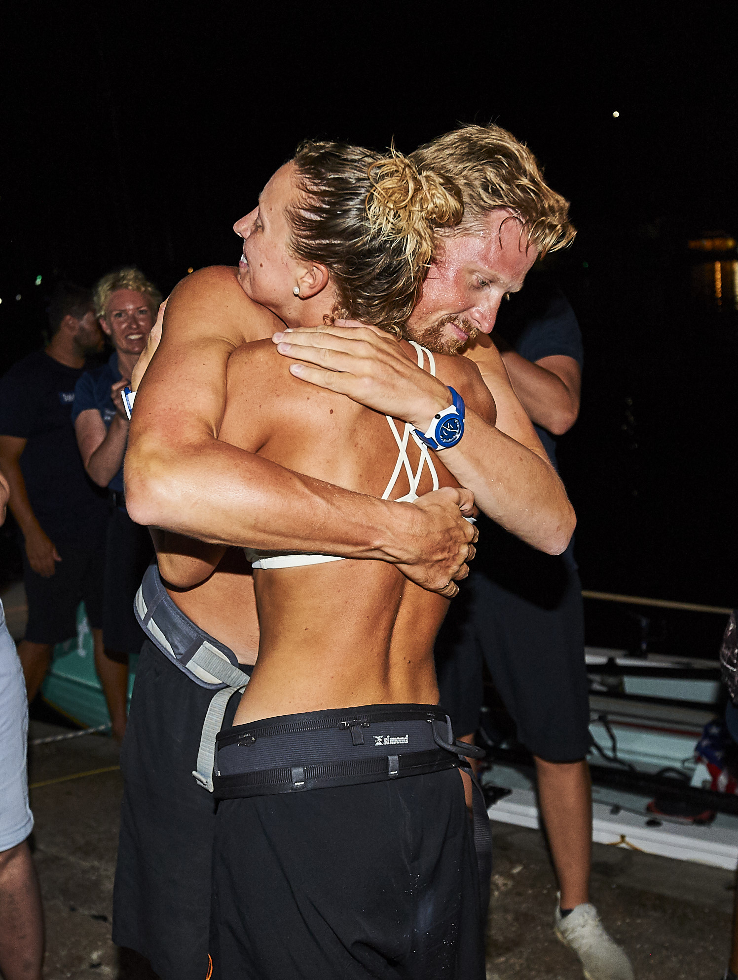 Anna and Cam McLean hug at the finish line after rowing across the Atlantic