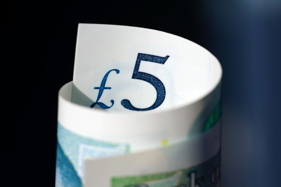 Close-up of a rolled-up five pound note