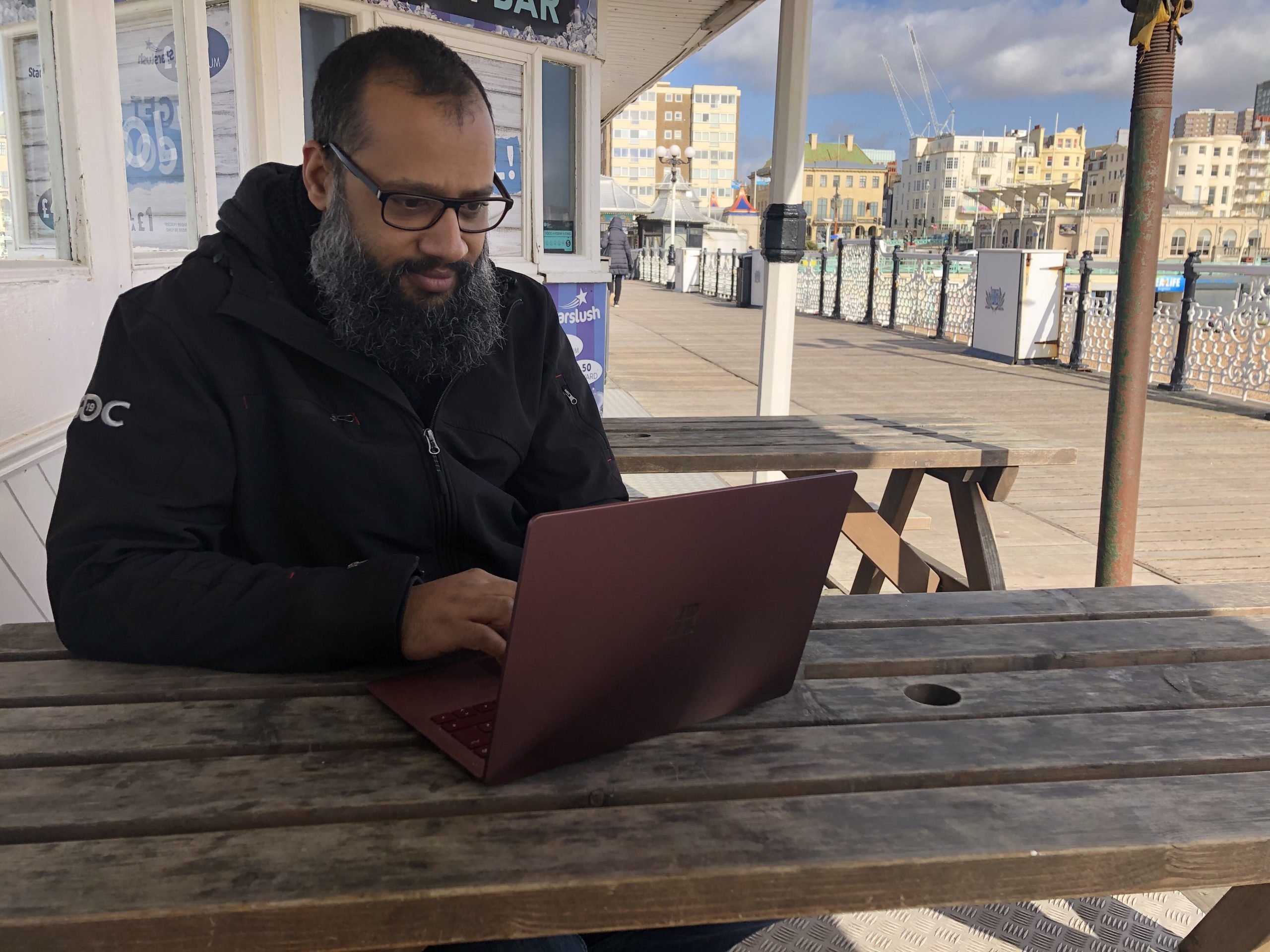 James Stone, a games developer in the ID@Xbox programme, uses a laptop on Brighton Palace Pier