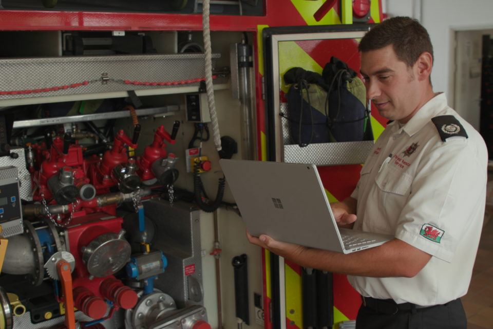 A fire officer from Mid and West Wales Fire and Rescue Service uses a Surface Book at Llanelli Fire Station