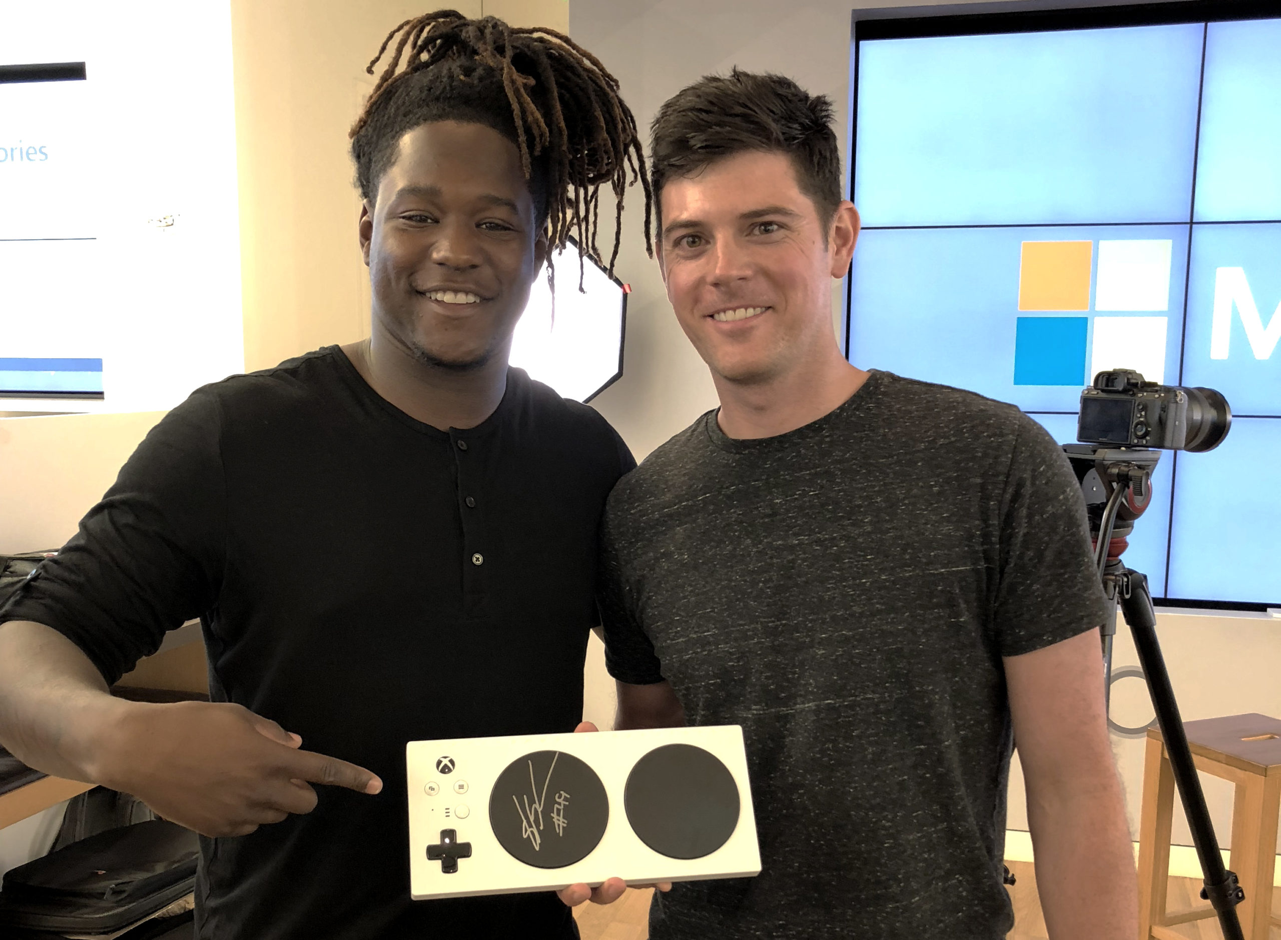Chris Kujawski (right) and Seattle Seahawks star Shaquem Griffin with the Xbox Adaptive Controller