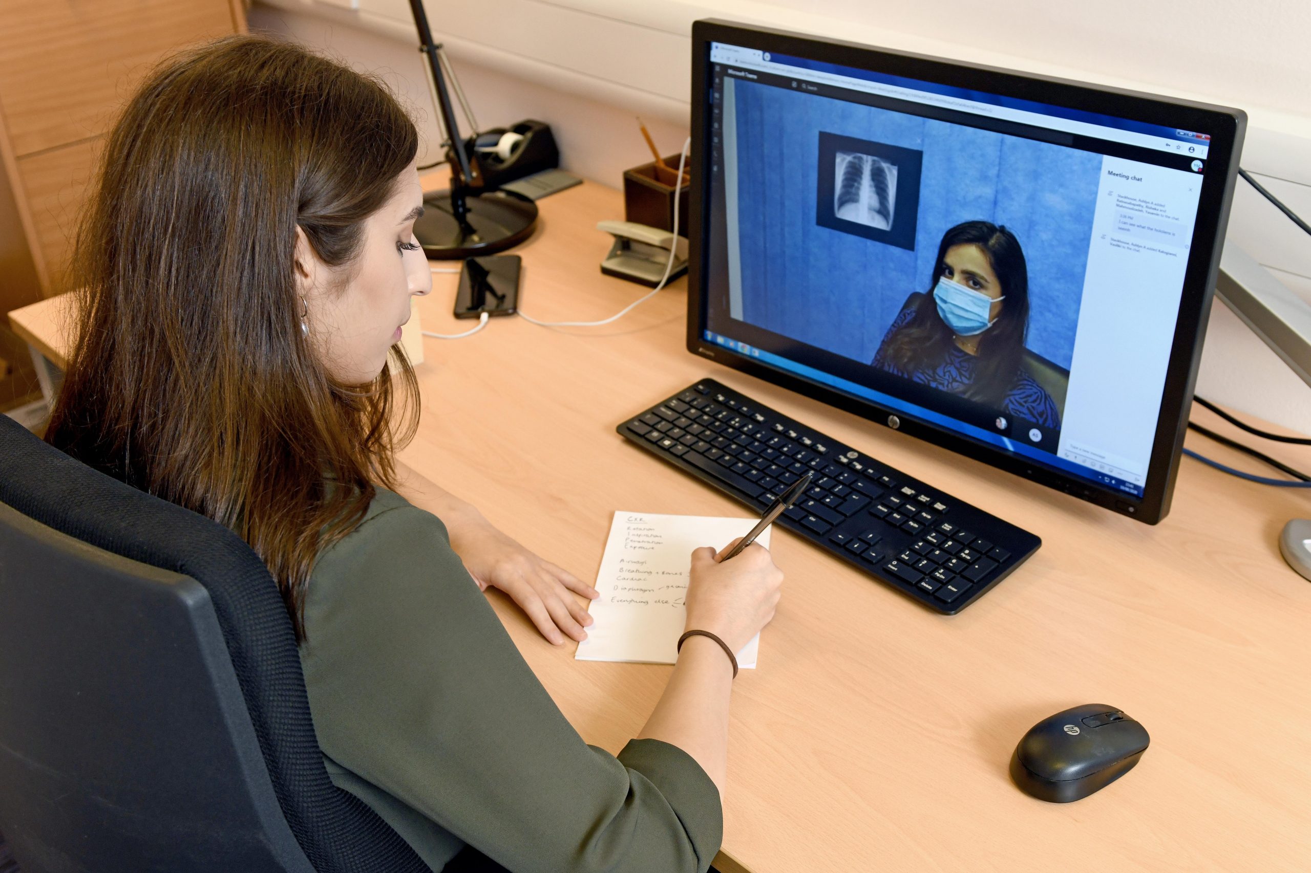 A female student looks at a computer screen showing a HoloLens recording