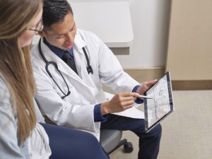 Doctor showing text results to a patient