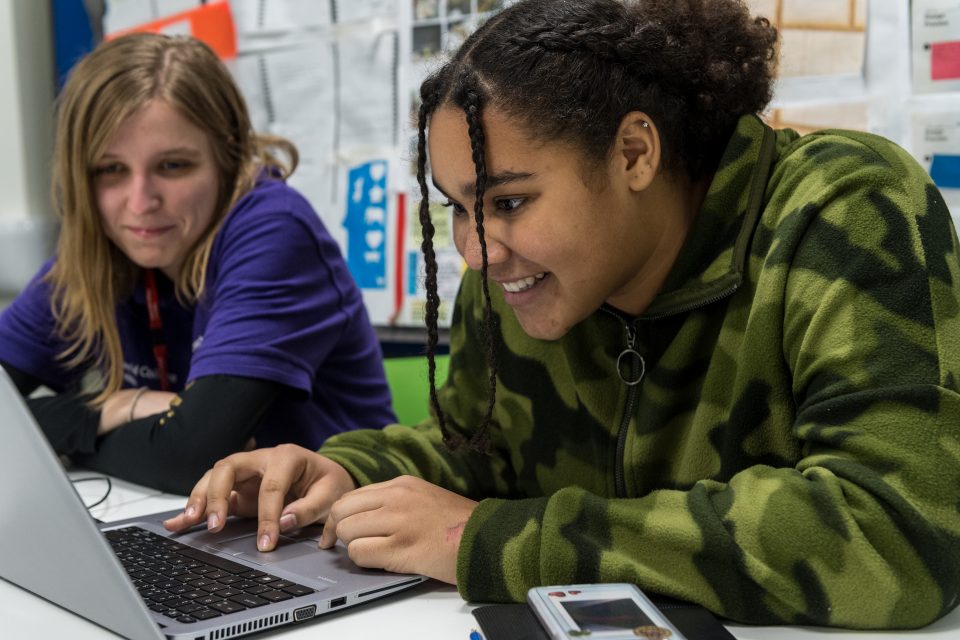 Two female students at Imperial College London look at a laptop screen