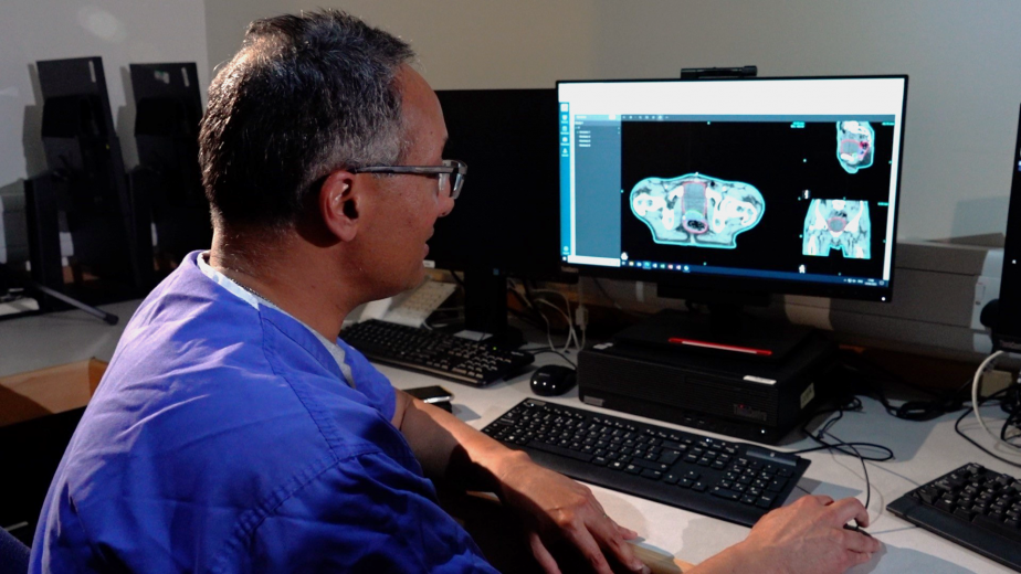 Dr. Raj Jena looks at the digital image of a scan on a computer screen