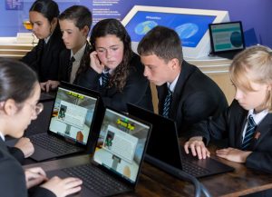 Students use laptops to play the Offshore Wind Power Challenge at the Rampion Visitor Centre