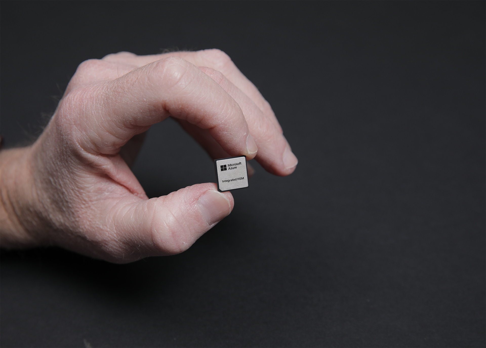 Hand holding an Azure Integrated HSM, Microsoft's new in-house security chip