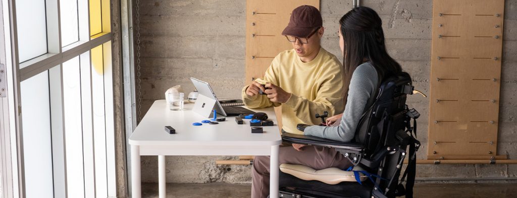 A woman and a man work together with gadgets and a Surface tablet