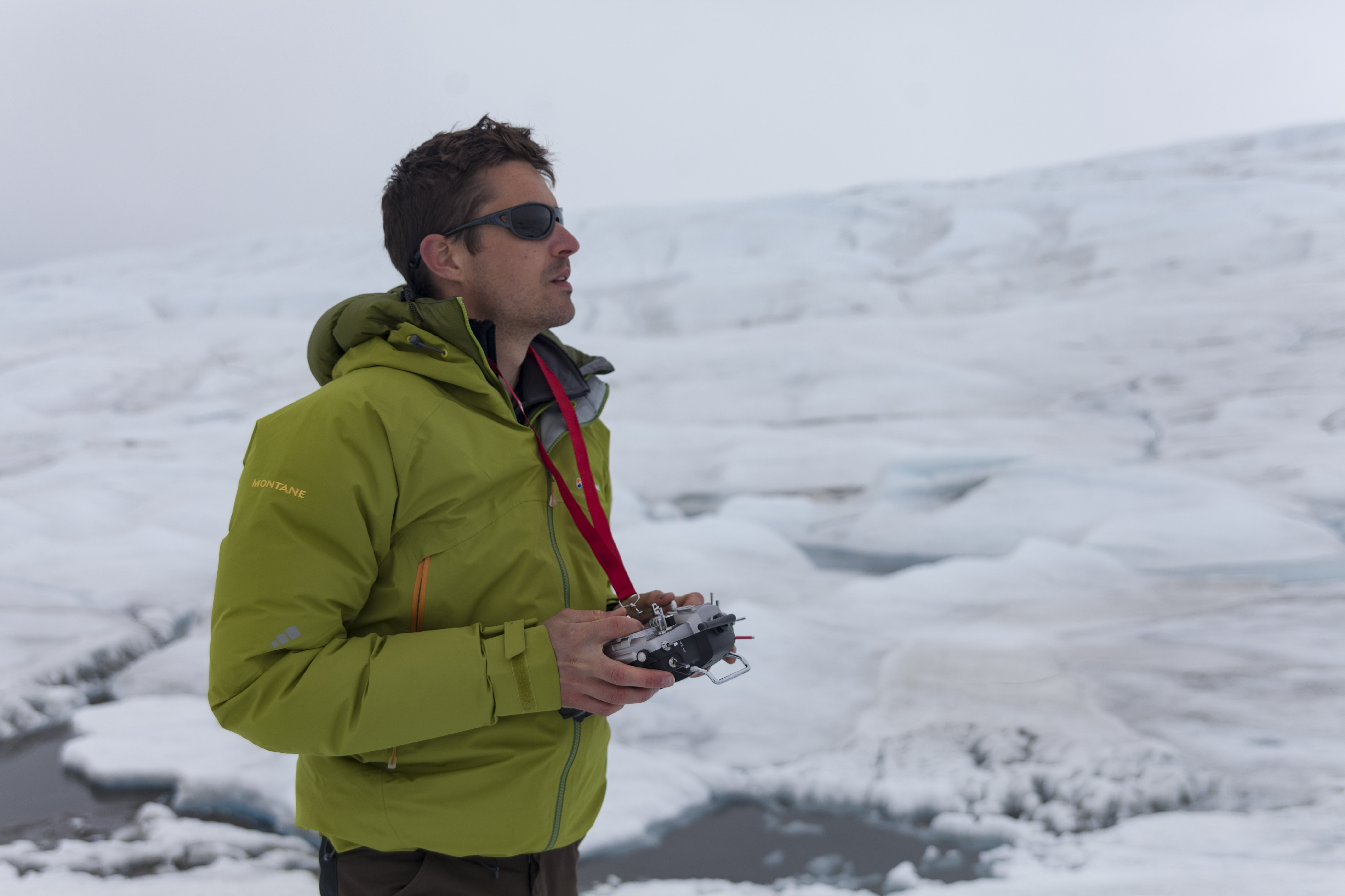 Joseph Cook piloting a drone in a snowy landscape