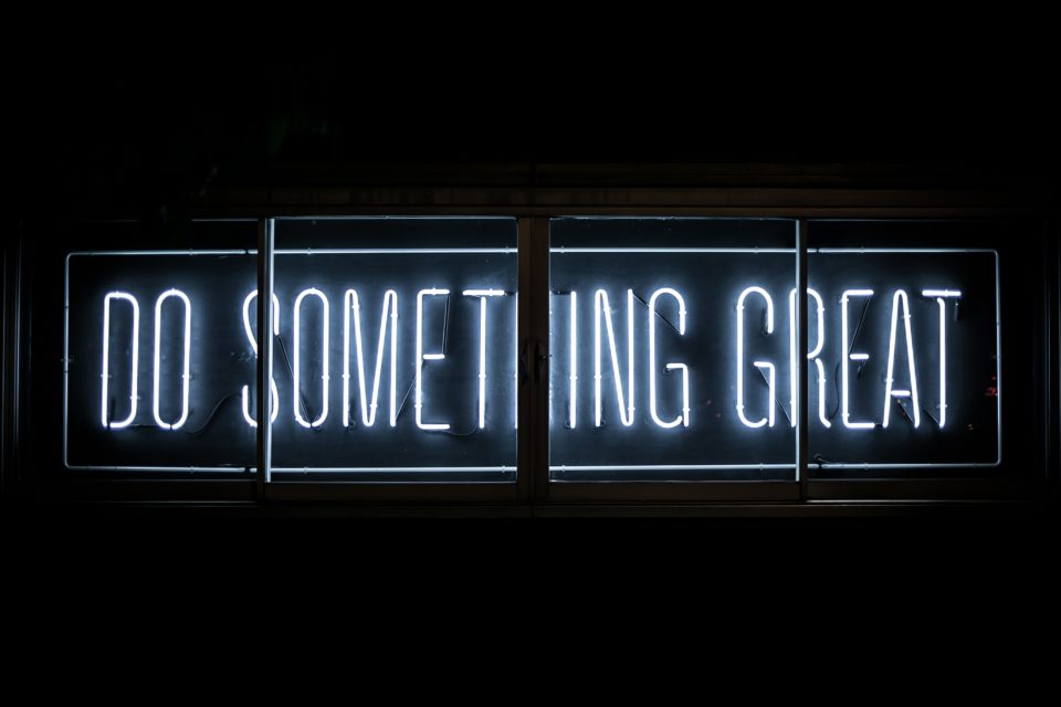 Neon sign stating: do something great