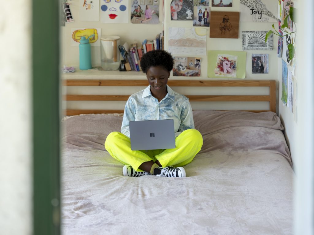 Young woman smiling looking at laptop