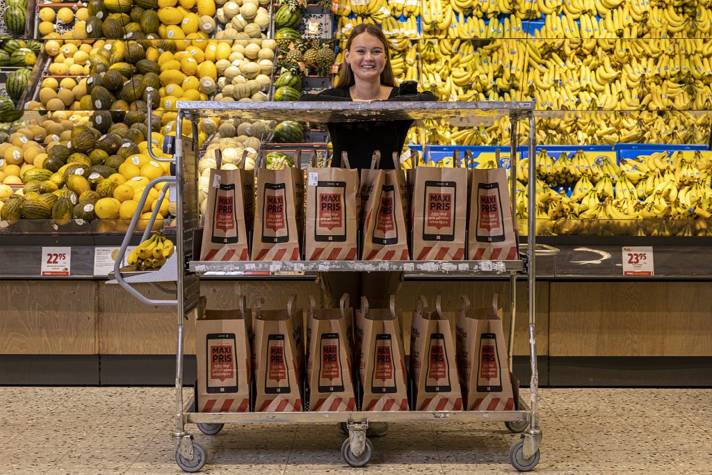 Grocery store worker with a purpose-built trolley