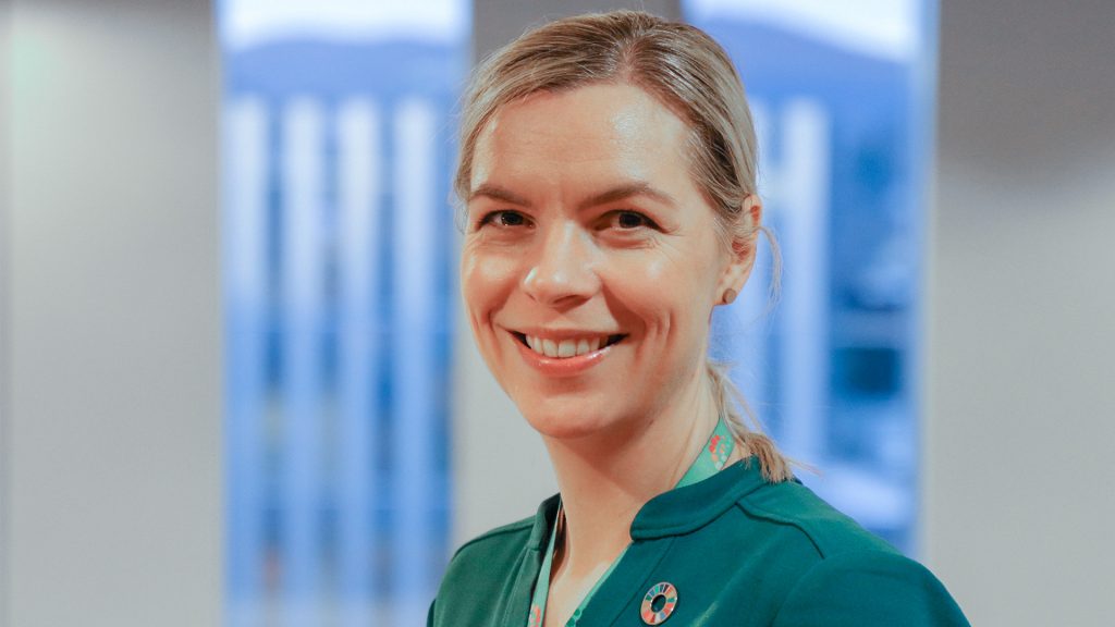 Hanne Rolén, head of sustainability for Aker Carbon Capture, in Oslo. Photo by Chris Welsch for Microsoft. A woman stands in front of a blue and white background