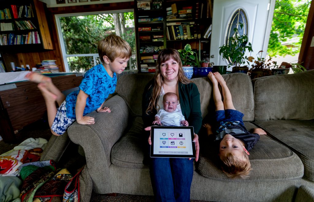 Autumn Parkinson and her sons, Ezra, Job and Isaac, at home with their CHAMP tablet. (Photography by Scott Eklund/Red Box Pictures)