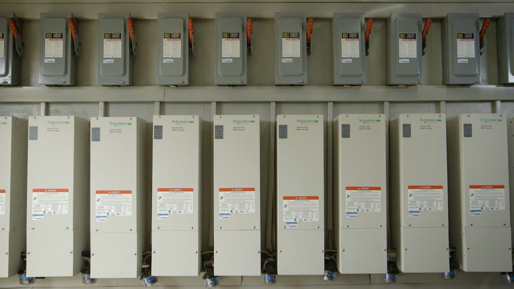 Inverters inside a Schneider Electric solar power system container.