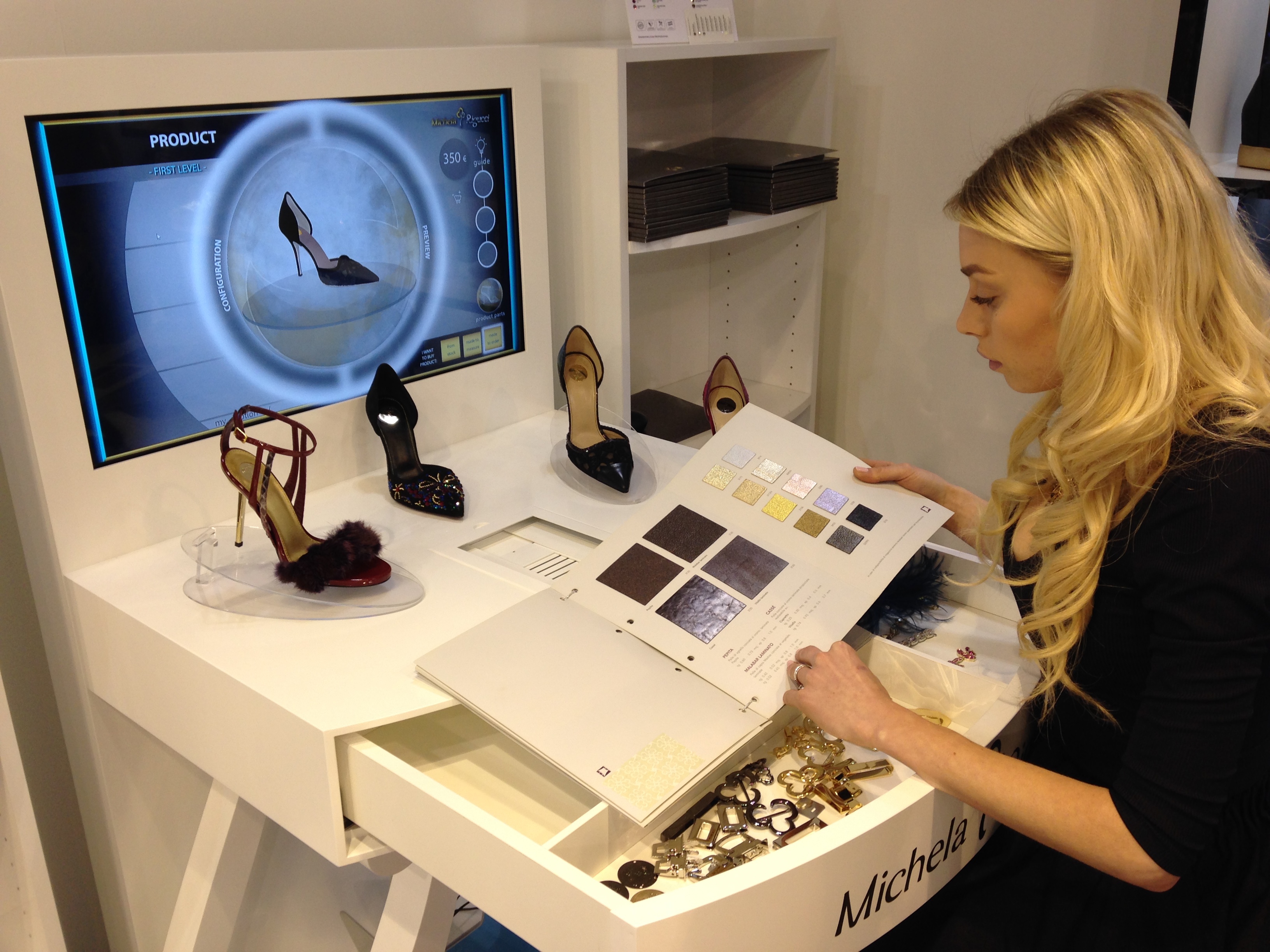 Woman looking at samples of customized features from Italian shoe brand Michela Rigucci