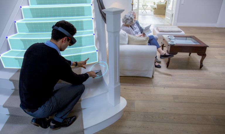 Man wears HoloLens headset while looking at holographic steps on a staircase