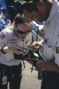 NASCAR officials use a tablet to keep the race fair and safe. (Image courtesy of Integrated Talent) 
