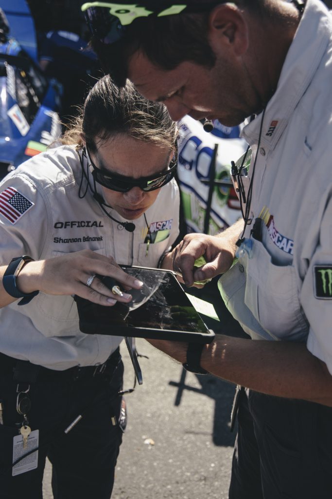 NASCAR officials use a tablet to keep the race safe. (Photo by Integrated Talent)