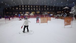 People snowboard at indoor ski and snow resort
